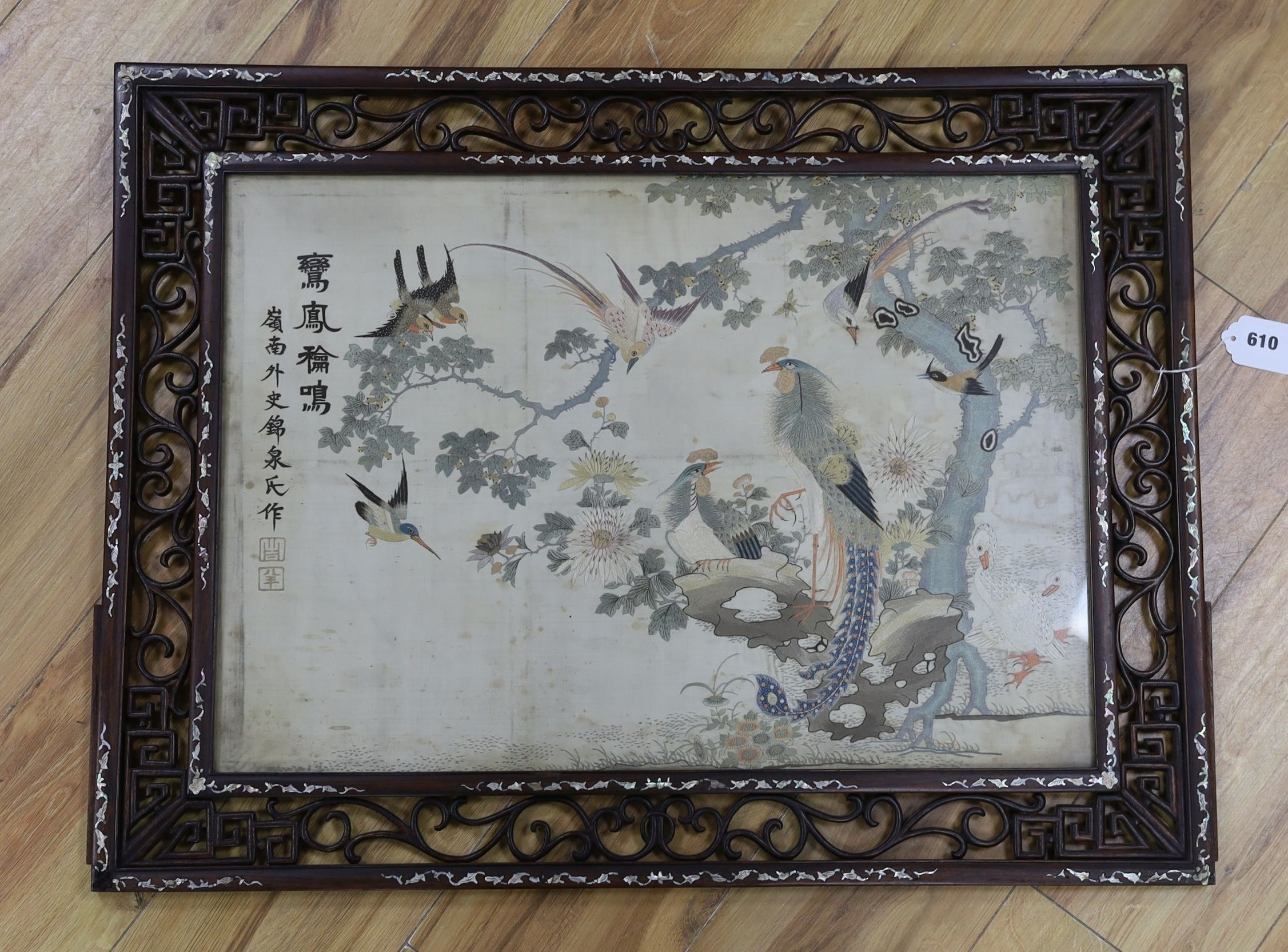 A Chinese mother of pearl inlaid framed and inscribed silk embroidery ‘of the hundred birds’, 78cms wide, 59cms high (including frame)